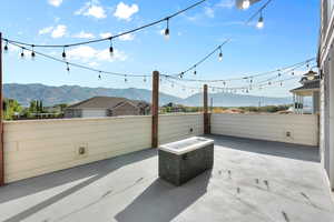 View of patio / terrace with a mountain view and a fire pit