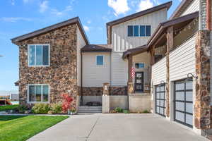 View of front of home with a garage and a front yard