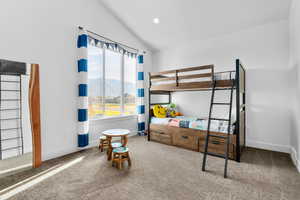 Bedroom with carpet floors, vaulted ceiling, and a mountain view