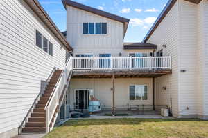 Rear view of property featuring a patio area and a yard