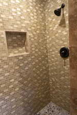 Bathroom featuring tiled shower