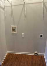 Clothes washing area featuring hookup for a washing machine, electric dryer hookup, and hardwood / wood-style flooring