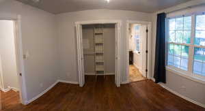 Unfurnished bedroom featuring a closet and dark hardwood / wood-style flooring