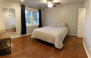 Bedroom featuring ceiling fan and dark hardwood / wood-style floors