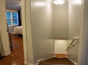 Staircase featuring hardwood / wood-style floors