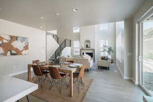 Dining room with a textured ceiling and light hardwood / wood-style floors