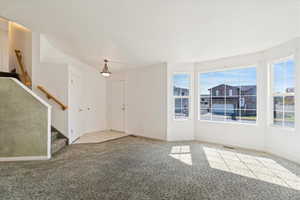 Entryway featuring light colored carpet