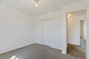 Unfurnished bedroom featuring a closet and carpet flooring