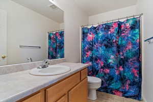 Bathroom with vanity, tile patterned flooring, and toilet