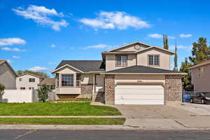 Front facade with a wide garage and a front lawn