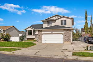 Front of property with extra wide garage and long RV pad