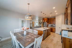 Dining room with light wood-type flooring and sink