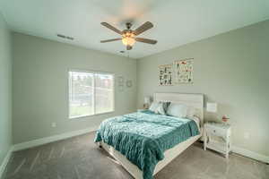 Bedroom featuring ceiling fan and carpet floors