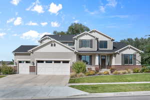 Craftsman-style house with a front lawn and a garage