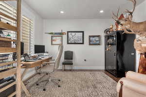 Home office with a textured ceiling and wood-type flooring