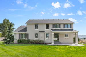 Rear view of property featuring a lawn