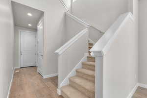 Staircase featuring hardwood / wood-style flooring