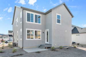 Rear view of property with central air condition unit and a patio area