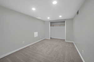 Unfurnished bedroom featuring light colored carpet and a closet