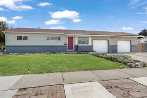 Single story home featuring a front lawn and a garage