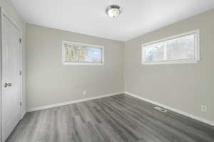 Spare room with hardwood / wood-style floors and a healthy amount of sunlight