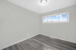 Empty room featuring hardwood / wood-style flooring