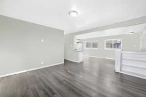 Unfurnished living room with dark hardwood / wood-style flooring