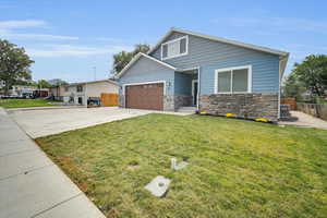 View of front facade with a garage and a front yard