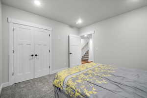 Basement Bedroom with carpet floors and a closet