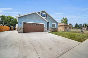 View of front of house featuring a front yard and a garage