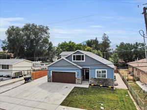 View of front facade with a garage and a front lawn