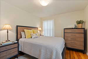 Bedroom with dark hardwood / wood-style floors