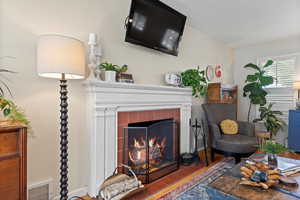 Living room featuring tile patterned floors and a tile fireplace