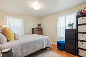 Bedroom with light hardwood / wood-style floors