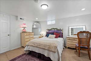 Carpeted bedroom featuring a textured ceiling