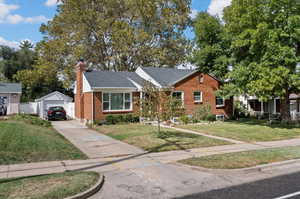 View of front of property featuring an outbuilding, a garage, and a front yard