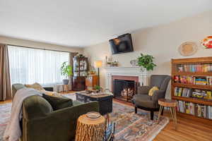 Living room with wood-type flooring and a fireplace