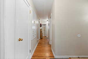 Hallway featuring light wood-type flooring