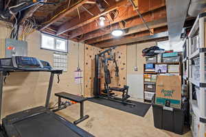 Workout area with electric panel and concrete flooring