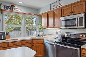 Kitchen featuring appliances with stainless steel finishes, sink, and a healthy amount of sunlight