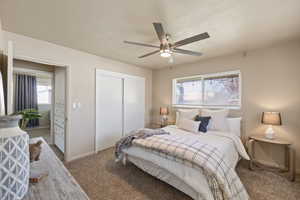 Bedroom featuring carpet floors, ceiling fan, and a closet