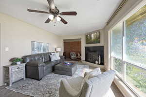 Living room featuring ceiling fan and carpet floors