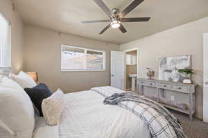 Carpeted bedroom with ceiling fan and sink