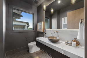 Bathroom featuring tile patterned floors, vanity, and toilet