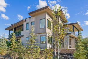 View of side of home with a balcony