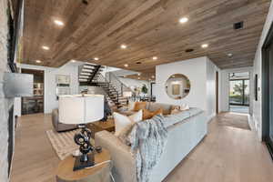 Living room with light hardwood / wood-style floors and wooden ceiling