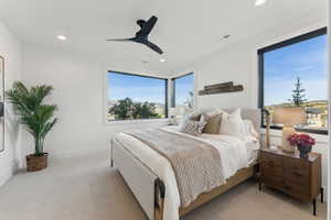 Bedroom featuring ceiling fan and light colored carpet