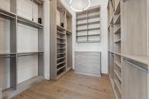 Walk in closet featuring light wood-type flooring