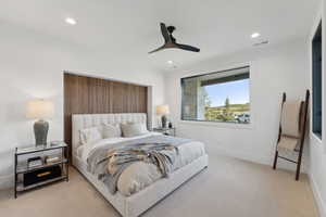 Carpeted bedroom with ceiling fan