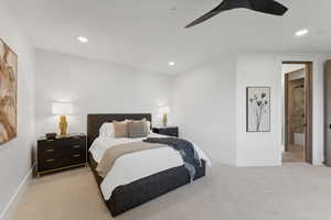 Bedroom with ceiling fan and light carpet